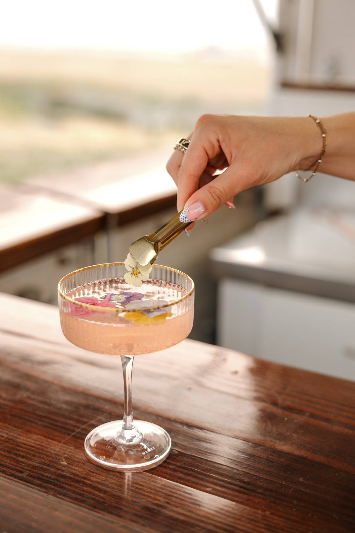 Close-up of a styled cocktail on the live-edge wood bar top$