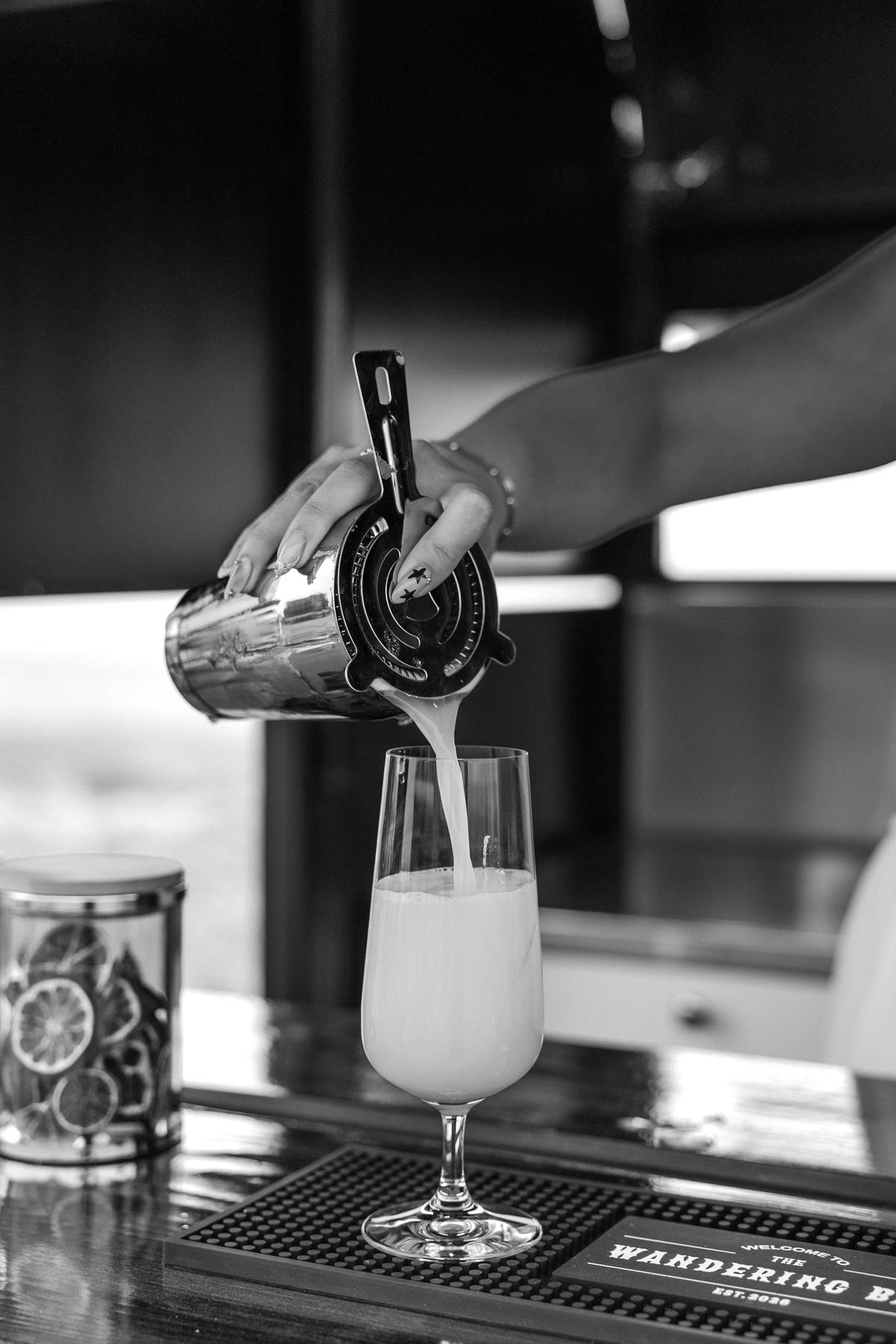 Bartender preparing a cocktail behind the trailer bar$