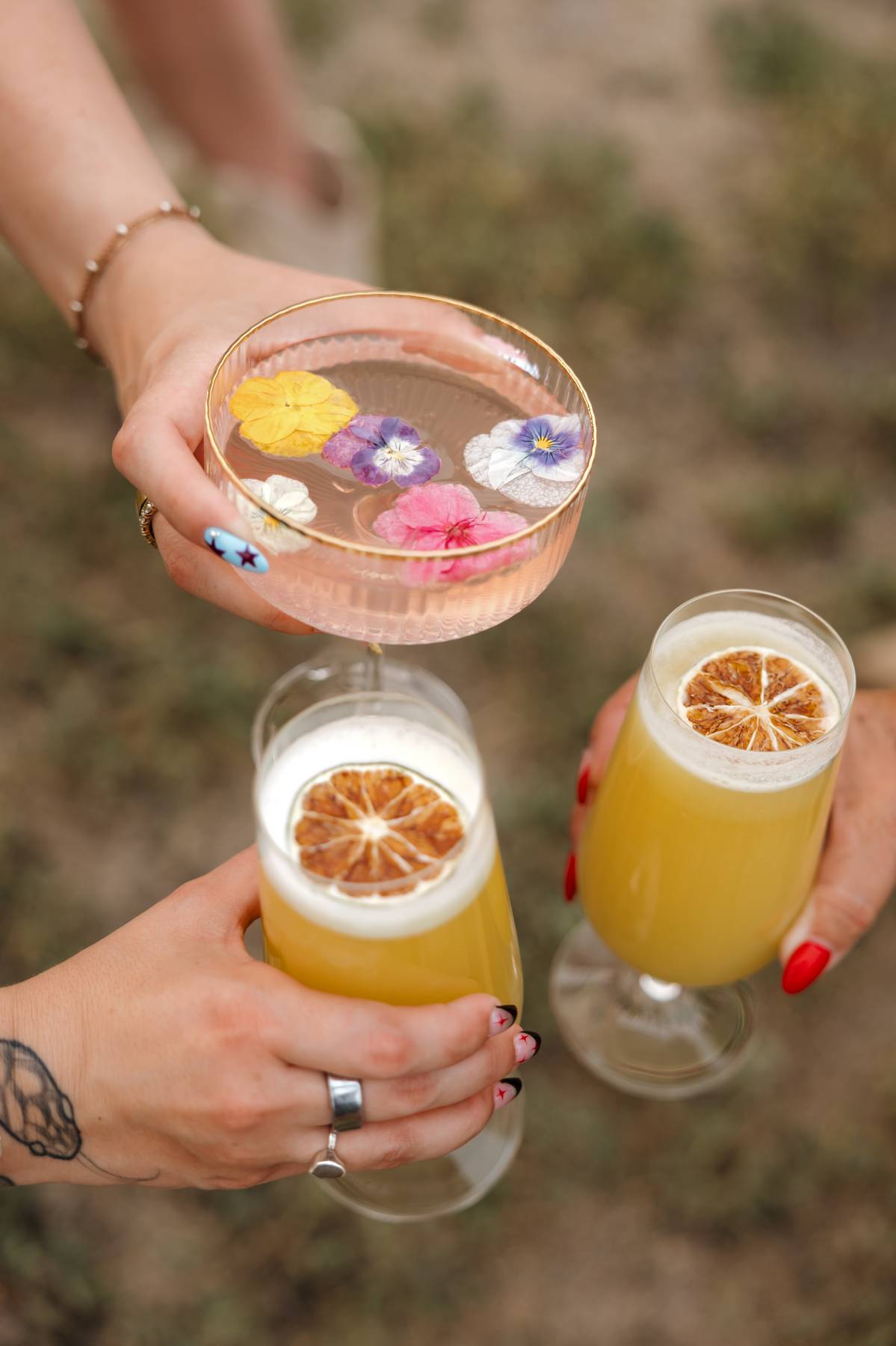 Three cocktails raised together in a toast$